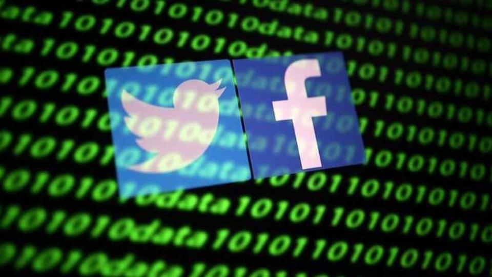 FILE PHOTO: The Twitter and Facebook logo along with binary cyber codes are seen in this illustration taken November 26, 2019. REUTERS/Dado Ruvic/Illustration/File Photo