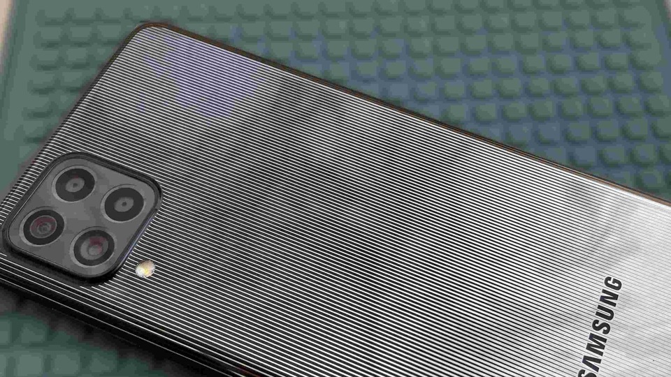 The back of the Galaxy F62 looks just like a mirror, with a sleek pinstripe design. 