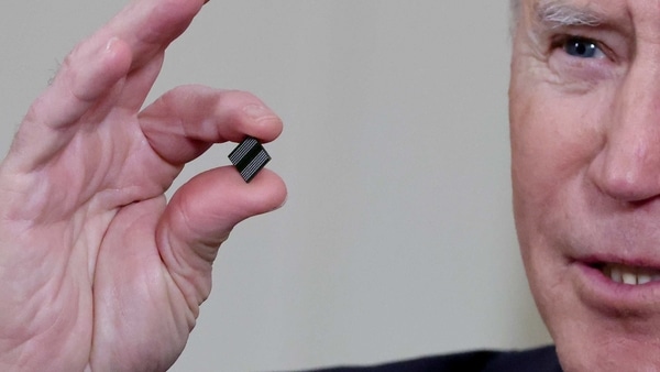 FILE PHOTO: U.S. President Joe Biden delivers holds a semiconductor chip as he speaks prior to signing an executive order, aimed at addressing a global semiconductor chip shortage, in the State Dining Room at the White House in Washington, U.S., February 24, 2021. REUTERS/Jonathan Ernst/File Photo