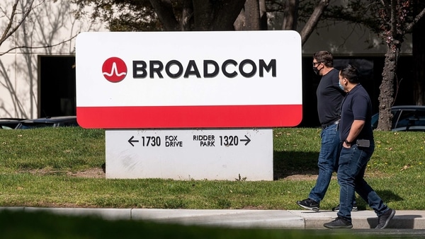 People wearing protective masks walk past the Broadcom Inc. headquarters in San Jose, California, U.S., on Tuesday, March 2, 2021. Broadcom Inc. is scheduled to release earnings figures on March 4. Photographer: David Paul Morris/Bloomberg
