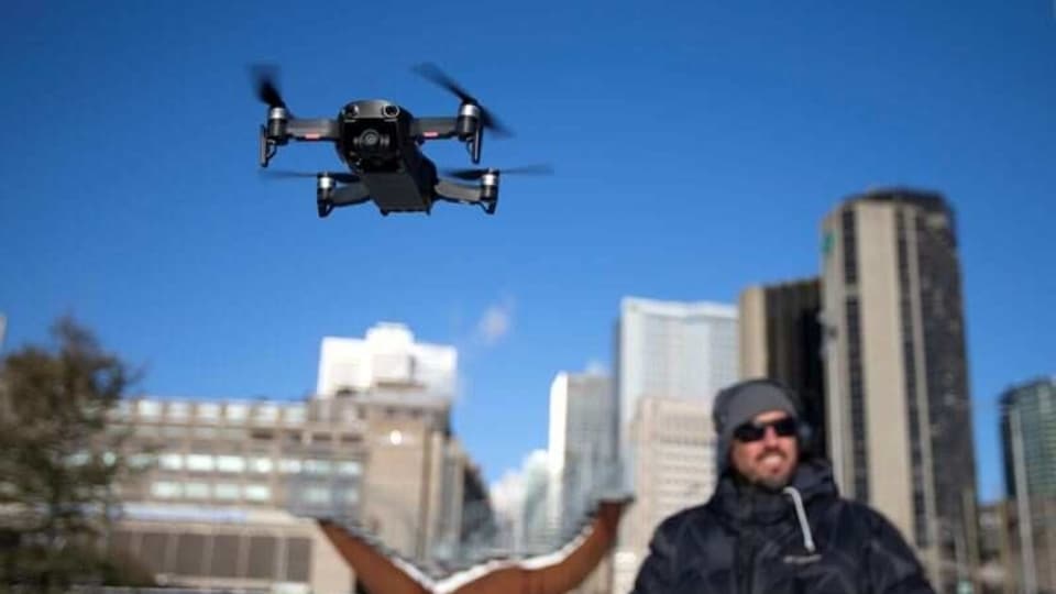 FILE PHOTO: A drone operator flies his drone as Chinese drone maker DJI holds a demonstration to display an app that tracks a drone's registration and owner in Montreal, Canada, November 13, 2019. REUTERS/Christinne Muschi/File Photo