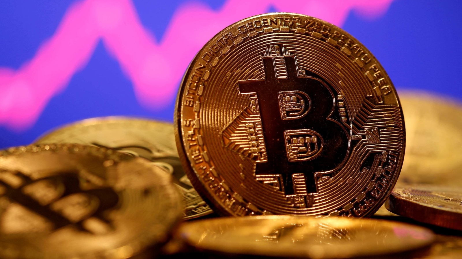 FILE PHOTO: A representation of virtual currency Bitcoin is seen in front of a stock graph in this illustration taken January 8, 2021. REUTERS/Dado Ruvic/File Photo/File Photo