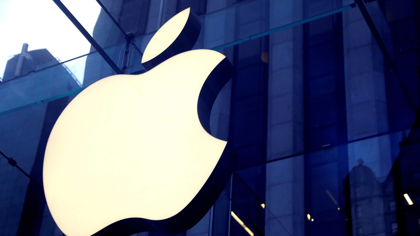 FILE PHOTO: The Apple Inc logo is seen hanging at the entrance to the Apple store on 5th Avenue in Manhattan, New York, U.S., October 16, 2019. REUTERS/Mike Segar/File Photo