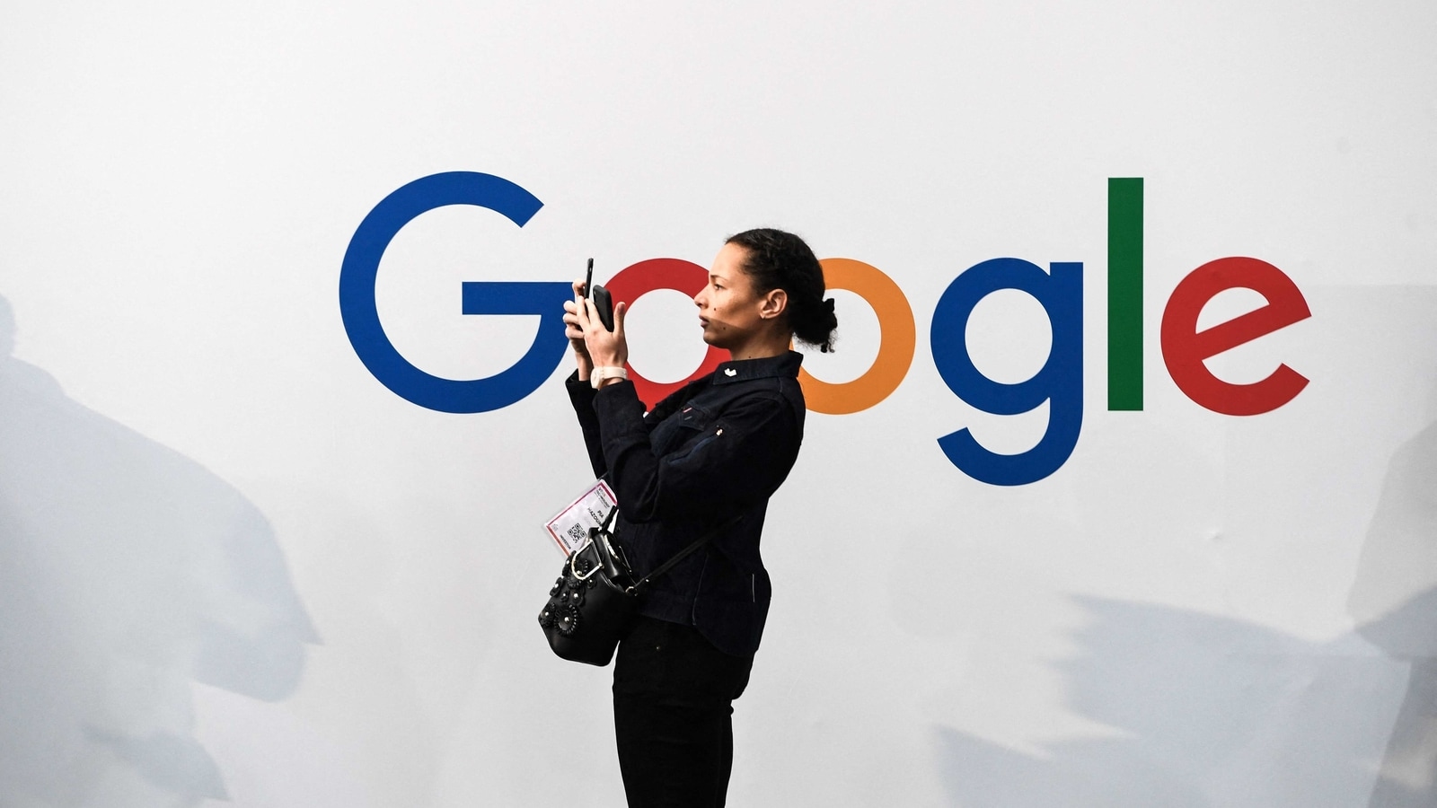 (FILES) In this file photo taken on May 16, 2019, a woman takes a picture with two smartphones in front of the logo of the US multinational technology and Internet-related services company Google as she visits the Vivatech startups and innovation fair, in Paris. - Google said on February 22, 2020 it would lift its ban on political ads on its platform imposed last month following the turmoil surrounding the violent uprising at the US Capitol. (Photo by ALAIN JOCARD / AFP) (FILES) In this file photo taken on May 16, 2019, a woman takes a picture with two smartphones in front of the logo of the US multinational technology and Internet-related services company Google as she visits the Vivatech startups and innovation fair, in Paris. - Google said on February 22, 2020 it would lift its ban on political ads on its platform imposed last month following the turmoil surrounding the violent uprising at the US Capitol. (Photo by ALAIN JOCARD / AFP)