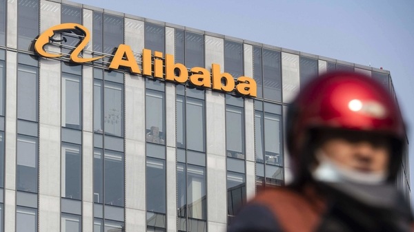 A motorist travels past an Alibaba Group Holding Ltd. office building in Shanghai, China.