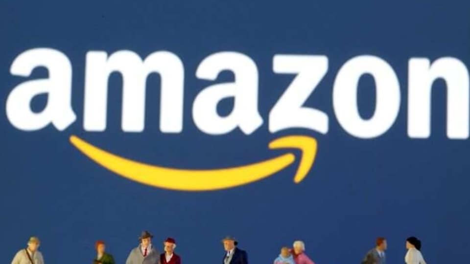 FILE PHOTO: Small toy figures are seen in front of diplayed Amazon logo in this illustration taken March 19, 2020. REUTERS/Dado Ruvic/Illustration/File Photo