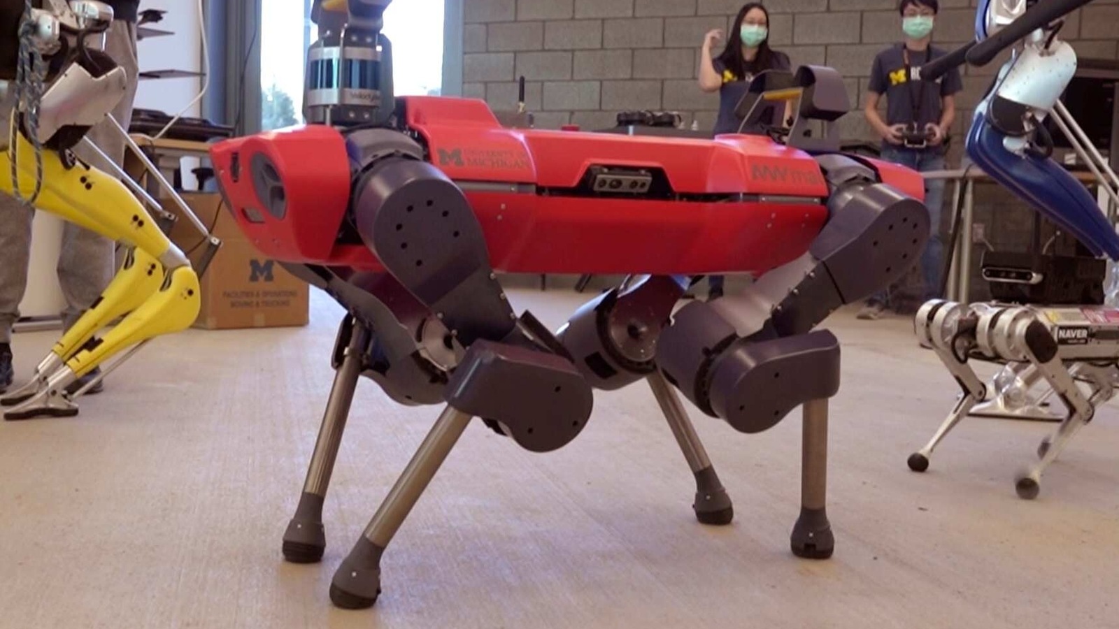 In a frame grab from video, robots walk across the floor of the University of Michigan's Ford Motor Co. Robotics Building, March 12, 2021 in Ann Arbor, Mich. The four-story, $75 million, 134,000-square-foot complex has three floors that house classrooms and research labs for robots that fly, walk, roll and augment the human body. (AP Photo/Carlos Osorio) In a frame grab from video, robots walk across the floor of the University of Michigan's Ford Motor Co. Robotics Building, March 12, 2021 in Ann Arbor, Mich. The four-story, $75 million, 134,000-square-foot complex has three floors that house classrooms and research labs for robots that fly, walk, roll and augment the human body. (AP Photo/Carlos Osorio)