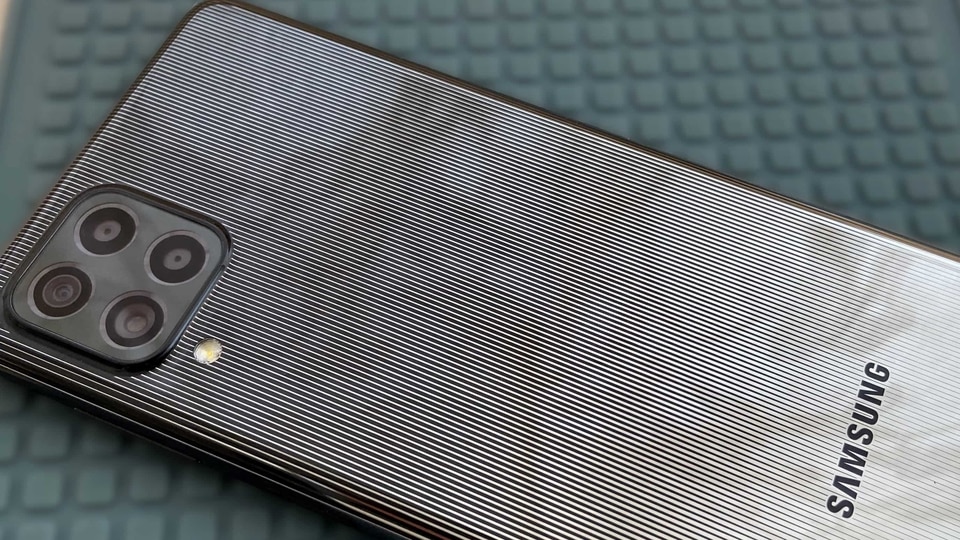 The back of the Galaxy F62 looks just like a mirror, with a sleek pinstripe design. 