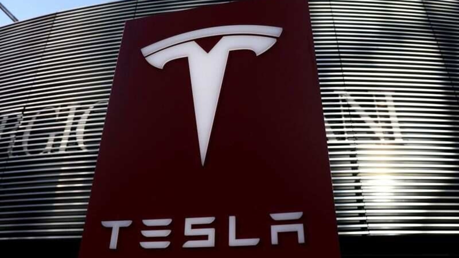 FILE PHOTO: A logo of electric vehicle maker Tesla is seen near a shopping complex in Beijing, China, January 5, 2021. REUTERS/Tingshu Wang/File Photo