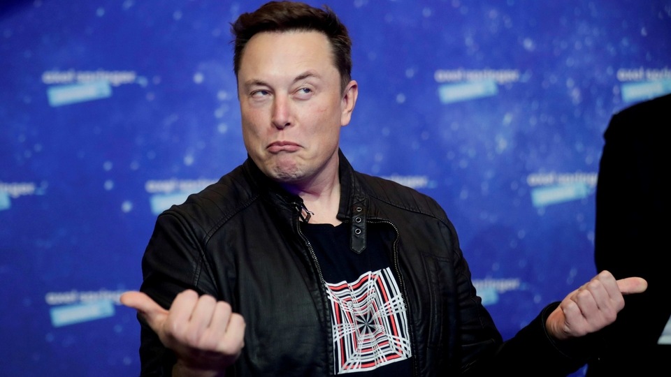 FILE PHOTO: SpaceX owner and Tesla CEO Elon Musk grimaces after arriving on the red carpet for the Axel Springer award, in Berlin, Germany, December 1, 2020. REUTERS/Hannibal Hanschke/Pool/File Photo/File Photo
