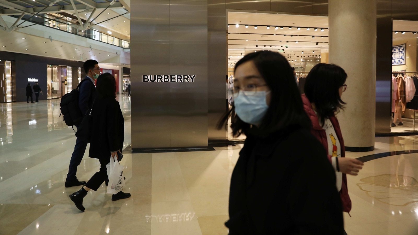 People walk past a store of luxury brand Burberry at a shopping mall in Beijing, China March 26, 2021. REUTERS/Tingshu Wang