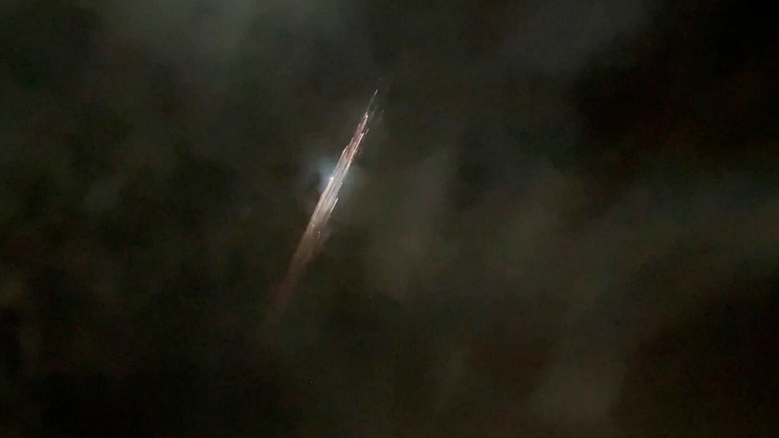 In this image taken from video provided by Roman Puzhlyakov, debris from a SpaceX rocket lights up the sky behind clouds over Vancouver, Wash. Thursday evening, March 25, 2021. The remnants of the second stage of the Falcon 9 rocket left comet-like trails as they burned up upon re-entry in the Earth's atmosphere according to a tweet from the National Weather Service. In this image taken from video provided by Roman Puzhlyakov, debris from a SpaceX rocket lights up the sky behind clouds over Vancouver, Wash. Thursday evening, March 25, 2021. The remnants of the second stage of the Falcon 9 rocket left comet-like trails as they burned up upon re-entry in the Earth's atmosphere according to a tweet from the National Weather Service.