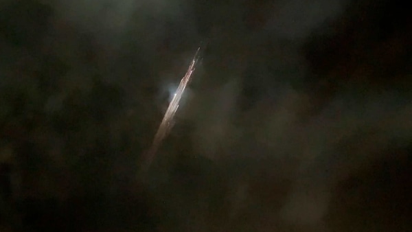 In this image taken from video provided by Roman Puzhlyakov, debris from a SpaceX rocket lights up the sky behind clouds over Vancouver, Wash. Thursday evening, March 25, 2021. The remnants of the second stage of the Falcon 9 rocket left comet-like trails as they burned up upon re-entry in the Earth's atmosphere according to a tweet from the National Weather Service. 