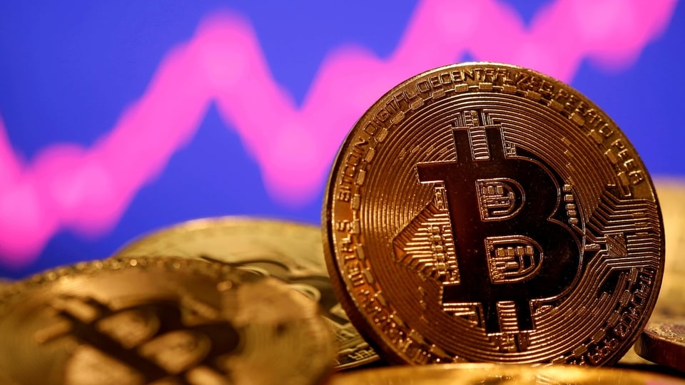FILE PHOTO: A representation of virtual currency Bitcoin is seen in front of a stock graph in this illustration taken January 8, 2021.