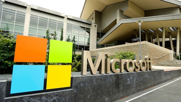 FILE - In this July 3, 2014, file photo, the Microsoft Corp. logo is displayed outside the Microsoft Visitor Center in Redmond, Wash. Microsoft will begin bringing workers back to its suburban Seattle global headquarters on March 29, 2021, as the tech giant starts to reopen more facilities it largely shuttered during the coronavirus pandemic. (AP Photo/Ted S. Warren, File)