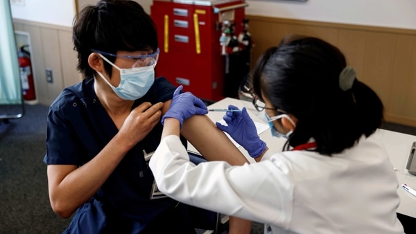 A medical worker receives a dose of the coronavirus disease (COVID-19) vaccine as Japan launches its inoculation campaign, at Tokyo Medical Center in Tokyo, Japan.