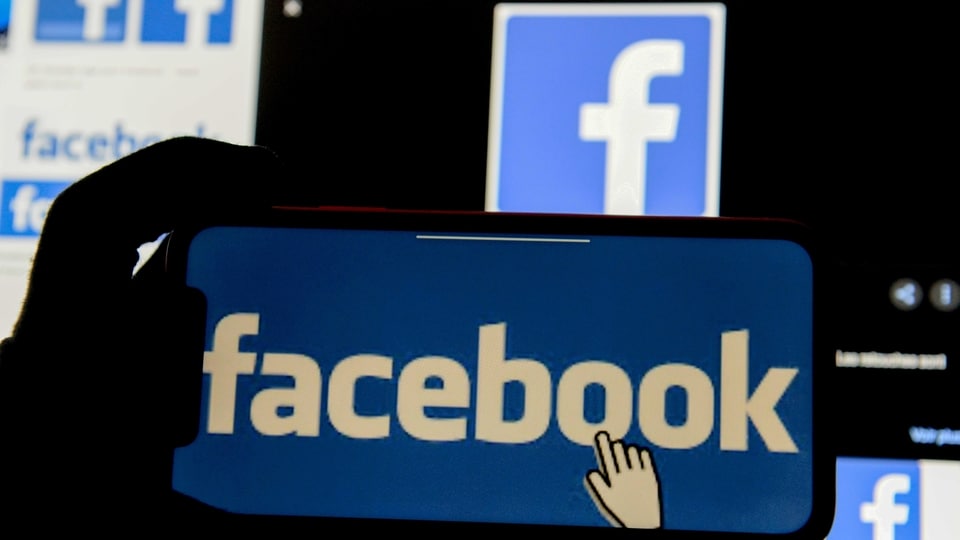 FILE PHOTO: The Facebook logo is displayed on a mobile phone in this picture illustration taken December 2, 2019. REUTERS/Johanna Geron/Illustration//File Photo