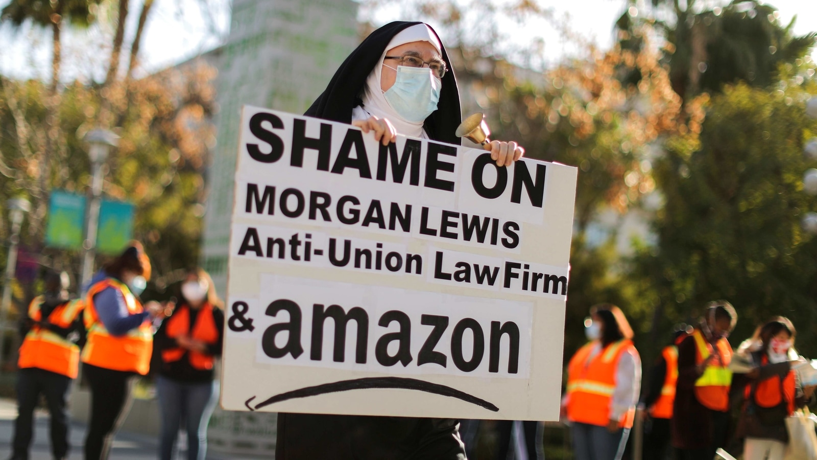 Jon Davidson dressed as a nun holds a banner, as people protest in support of the unionizing efforts of the Alabama Amazon workers, in Los Angeles, California, US, March 22, 2021. 