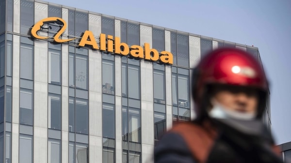 A motorist travels past an Alibaba Group Holding Ltd. office building in Shanghai, China, on Thursday, Dec. 24, 2020. China kicked off an investigation into alleged monopolistic practices at Alibaba and summoned affiliate Ant Group Co. to a high-level meeting over financial regulations, escalating scrutiny over the twin pillars of billionaire Jack Ma's internet empire.