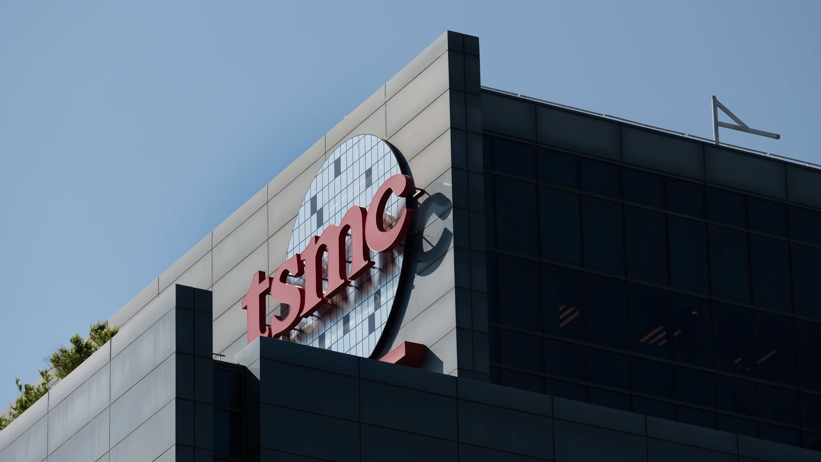 Logo at the Taiwan Semiconductor Manufacturing Co. headquarters in Hsinchu, Taiwan, on Wednesday, April 7, 2021. The TSMC�is a key supplier to Apple, and it�s the iPhone maker�s commitment to become carbon neutral by 2030 that is driving much of the change throughout the supply chain. Photographer: Billy H.C. Kwok/Bloomberg