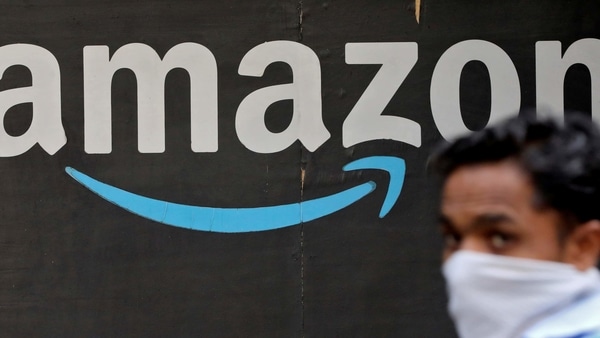 FILE PHOTO: A man walks past an Amazon logo outside the company's collection point in Mumbai, India, March 19, 2021. REUTERS/Francis Mascarenhas/File Photo