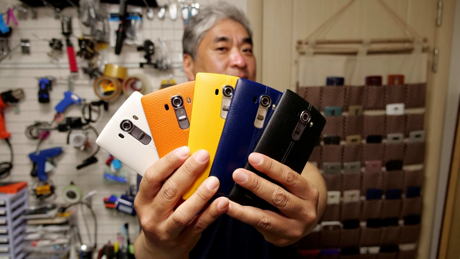 Ryu Hyun-soo, 53, holds his LG smartphones in Anyang, South Korea April 12, 2021. Picture taken April 12, 2021. REUTERS/Daewoung Kim