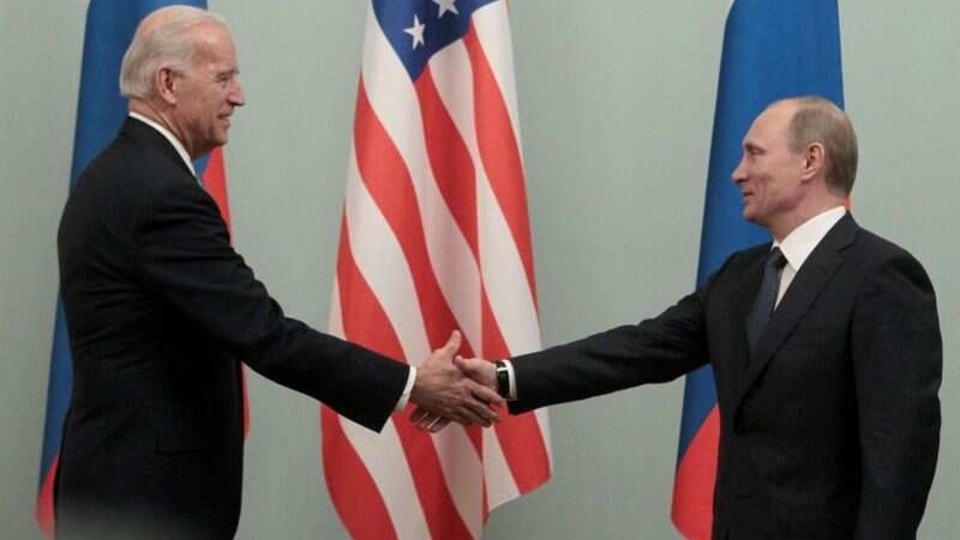 FILE PHOTO: Russian Prime Minister Vladimir Putin (R) shakes hands with (then) US Vice President Joe Biden during their meeting in Moscow March 10, 2011.