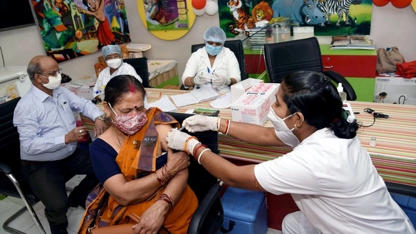 A beneficiary receives the second dose of the Covid-19 vaccine, amid rising coronavirus cases across the country, at a government dispensary in Patna. 