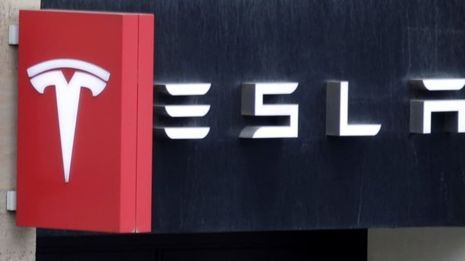 FILE PHOTO: The logo of Tesla is seen on a store in Paris, France, October 30, 2020. REUTERS/Charles Platiau