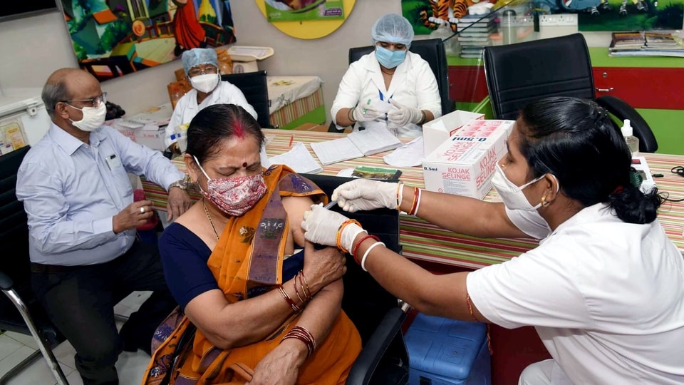 A beneficiary receives the second dose of the Covid-19 vaccine, amid rising coronavirus cases across the country, at a government dispensary in Patna. 
