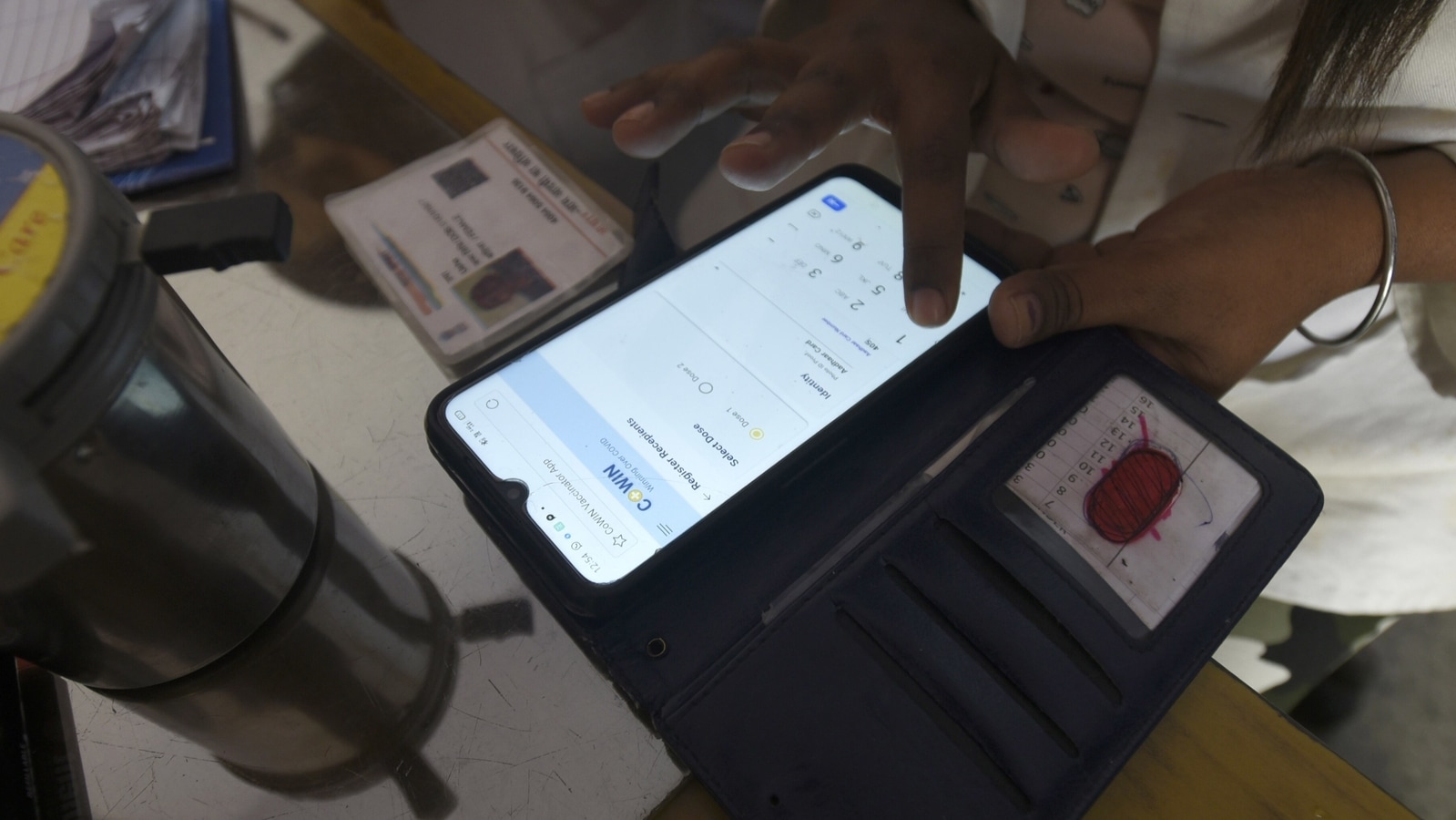 Noida, India - March 25, 2021: A health worker registering a person on the CoWin app for Covid-19 vaccination, at sector 22 (UPHC) urban primary health centre, in Noida, India, on Thursday, March 25, 2021. 