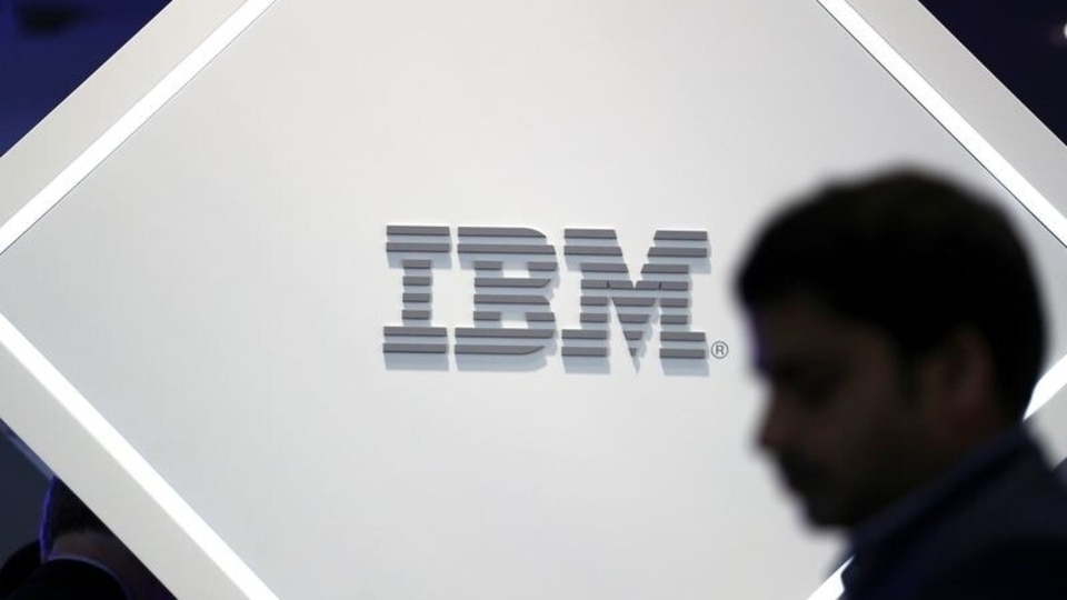 FILE PHOTO: A man stands near an IBM logo at the Mobile World Congress in Barcelona, Spain, February 25, 2019. 