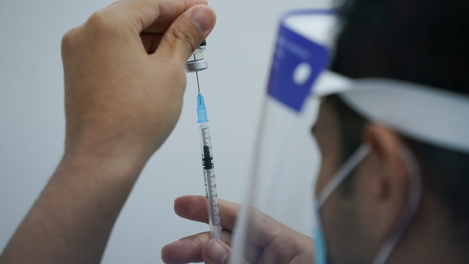 A health worker prepares to administer the Pfizer's COVID-19 vaccine at a vaccination center in Subang Jaya, Malaysia, Tuesday, April 27, 2021. (AP Photo/Vincent Thian)