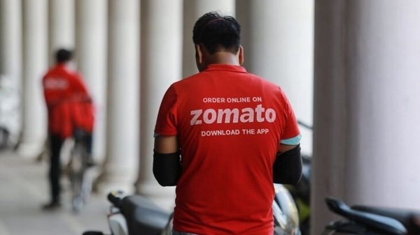 A delivery worker of Zomato, an Indian food-delivery startup, waits to collect an order from a restaurant, during an extended nationwide lockdown to slow the spread of the coronavirus disease (COVID-19), in New Delhi, India, May 21, 2020. 