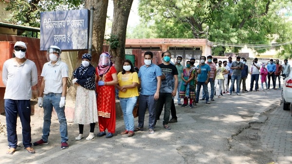 People over 18 years of age wait in a queue to receive their doses of COVID-19 vaccine, at a vaccination centre in Prayagraj on Tuesday. 