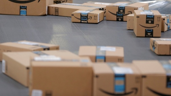 FILE PHOTO: Packages emblazoned with Amazon logos travel along a conveyor belt inside of an Amazon fulfillment center in Robbinsville, New Jersey, U.S., November 27, 2017.  REUTERS/Lucas Jackson/File Photo