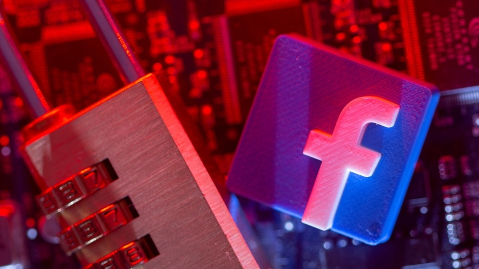 A 3D printed Facebook logo and a padlock are placed on a computer motherboard in this illustration picture taken May 4, 2021. REUTERS/Dado Ruvic/Illustration