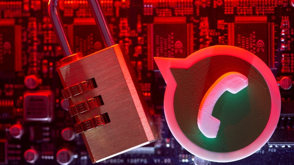 A 3D printed Whatsapp logo and a padlock are placed on a computer motherboard in this illustration picture taken May 4, 2021. REUTERS/Dado Ruvic/Illustration