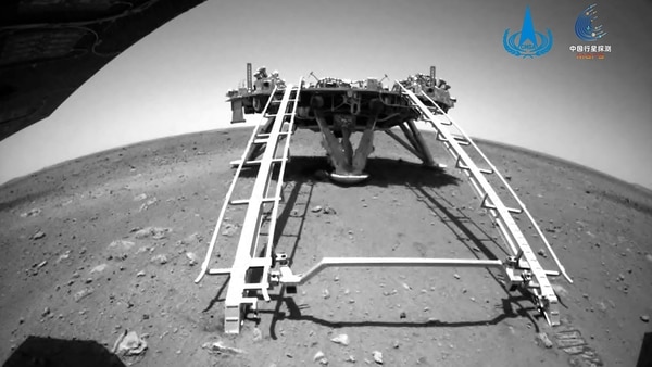 In this image released by the China National Space Administration (CNSA) on Saturday, May 22, 2021, a landing platform and the surface of Mars are seen from a camera on the Chinese Mars rover Zhurong. China's first Mars rover has driven down from its landing platform and is now roaming the surface of the red planet, China's space administration said Saturday. 