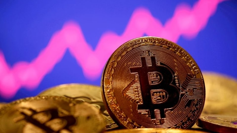 FILE PHOTO: A representation of virtual currency Bitcoin is seen in front of a stock graph in this illustration taken January 8, 2021. REUTERS/Dado Ruvic