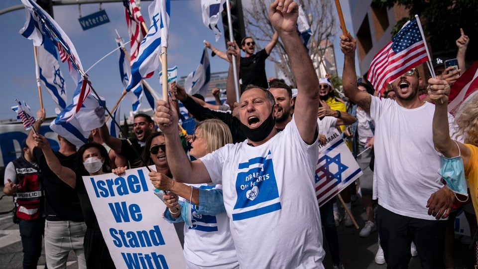 Pro-Israel supporters chant slogans during a rally in support of Israel outside the Federal Building in Los Angeles, Wednesday, May 12, 2021. A larger debate is playing out nationwide among many U.S. Jews who are divided over how to respond to the violence and over the disputed boundaries for acceptable criticism of Israeli policies. 