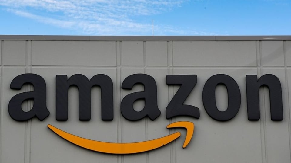 FILE PHOTO: The Amazon logo is seen outside its JFK8 distribution center in Staten Island, New York, U.S. November 25, 2020.  REUTERS/Brendan McDermid.