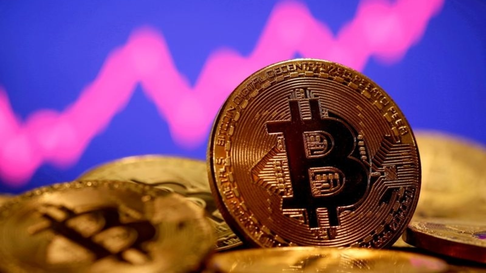 FILE PHOTO: A representation of virtual currency Bitcoin is seen in front of a stock graph in this illustration taken January 8, 2021. REUTERS/Dado Ruvic