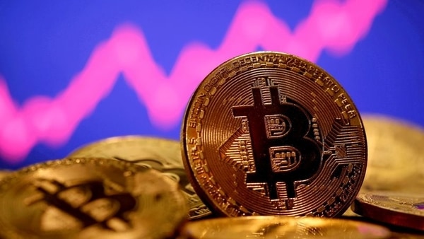 FILE PHOTO: A representation of virtual currency Bitcoin is seen in front of a stock graph in this illustration taken January 8, 2021. REUTERS/Dado Ruvic