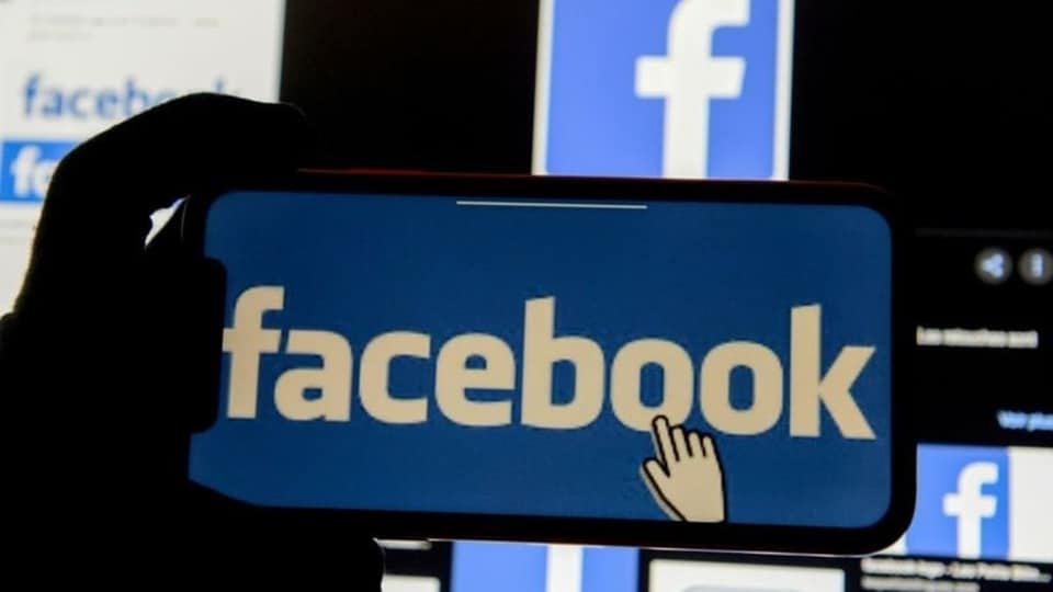 FILE PHOTO: The Facebook logo is displayed on a mobile phone in this picture illustration taken December 2, 2019. REUTERS/Johanna Geron/Illustration