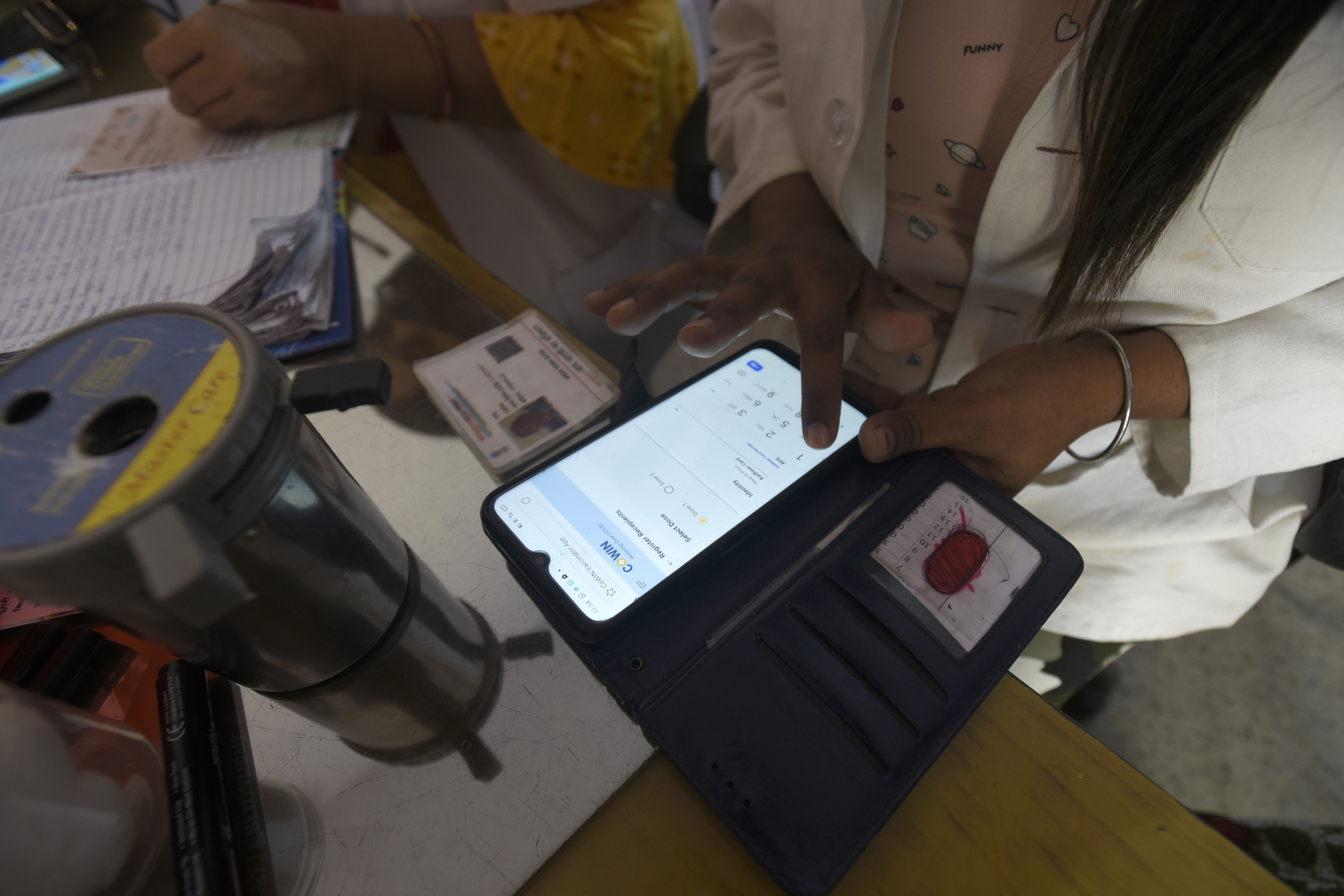 FILE PHOTO: A health worker registering a person on the CoWIN app for Covid-19 vaccination, at sector 22 (UPHC) urban primary health centre, in Noida, India, on Thursday, March 25, 2021. FILE PHOTO: A health worker registering a person on the CoWIN app for Covid-19 vaccination, at sector 22 (UPHC) urban primary health centre, in Noida, India, on Thursday, March 25, 2021.