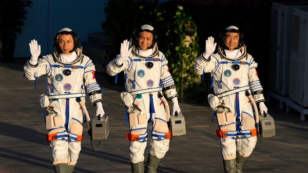 Jiuquan : Chinese astronauts, from left, Tang Hongbo, Nie Haisheng, and Liu Boming wave as they prepare to board for liftoff at the Jiuquan Satellite Launch Center in Jiuquan in northwestern China, Thursday, June 17, 2021. China plans on Thursday to launch three astronauts onboard the Shenzhou-12 spaceship who will be the first crew members to live on China's new orbiting space station Tianhe, or Heavenly Harmony.