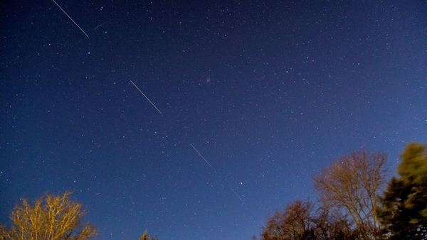 FILE PHOTO: SpaceX Starlink 5 satellites are pictured in the sky seen from Svendborg on South Funen, Denmark April 21, 2020. Picture taken with long exposure.