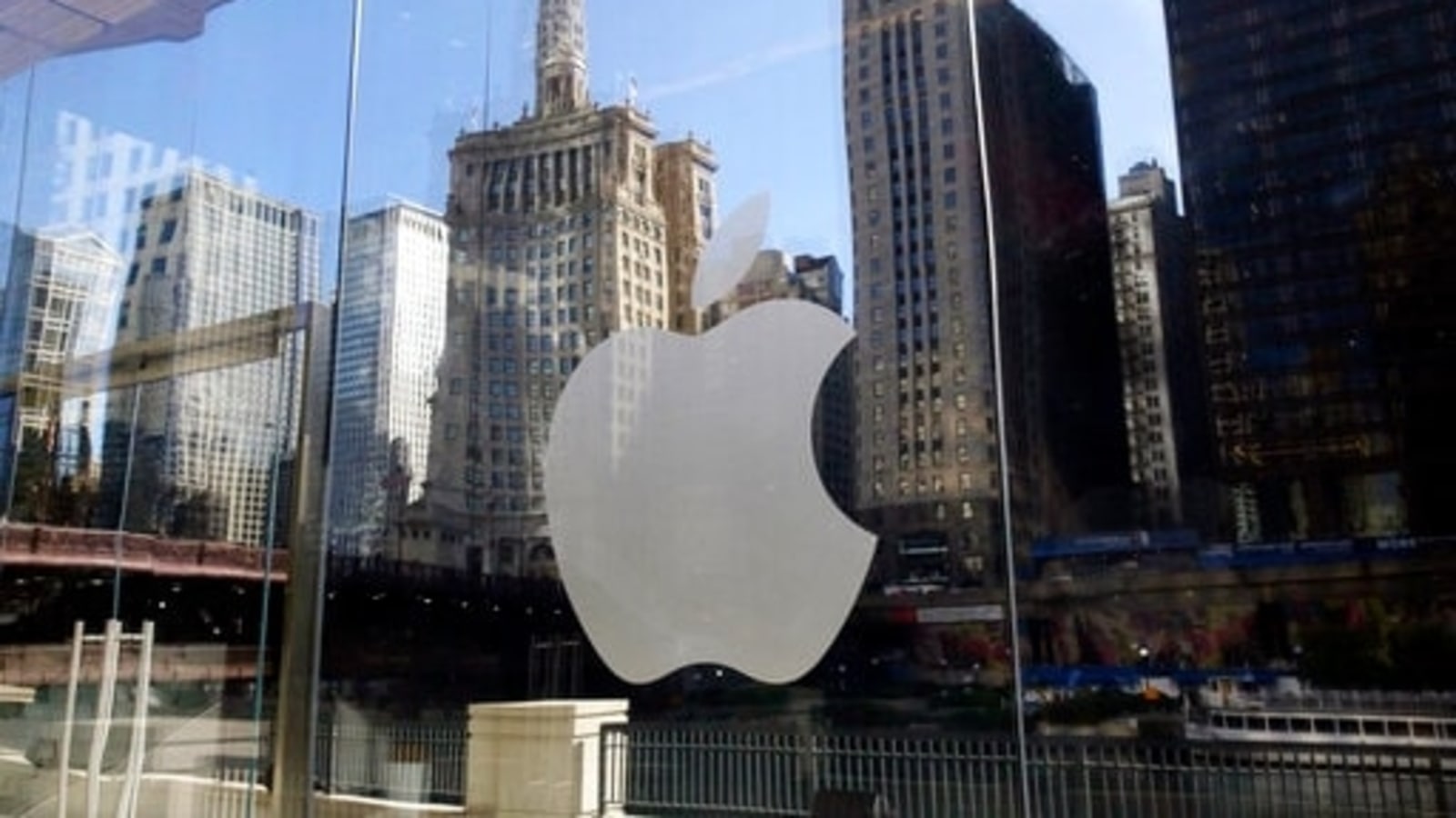 FILE - In this Thursday, Oct. 19, 2017, file photo, buildings are reflected behind the logo at an Apple Store in downtown Chicago. Apple Music is coming to a city near you — the streaming service launched daily music charts focused on particular cities around the world on Monday, April 26, 2021. (AP Photo/Kiichiro Sato, File)