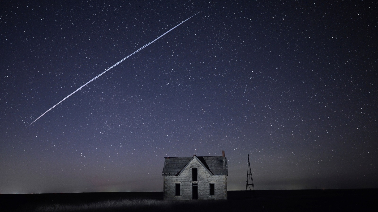 In this photo made with a long exposure, a string of SpaceX StarLink satellites passes over an old stone house near Florence, Kan., on Thursday, May 6, 2021. In this photo made with a long exposure, a string of SpaceX StarLink satellites passes over an old stone house near Florence, Kan., on Thursday, May 6, 2021.